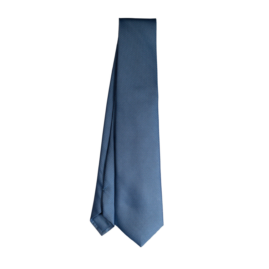 cravatta finto unito azzurro sette pieghe punta spillo realizzata a mano in Italia. Cravatta sartoriale punta spillo azzurro/grigio sette pieghe.