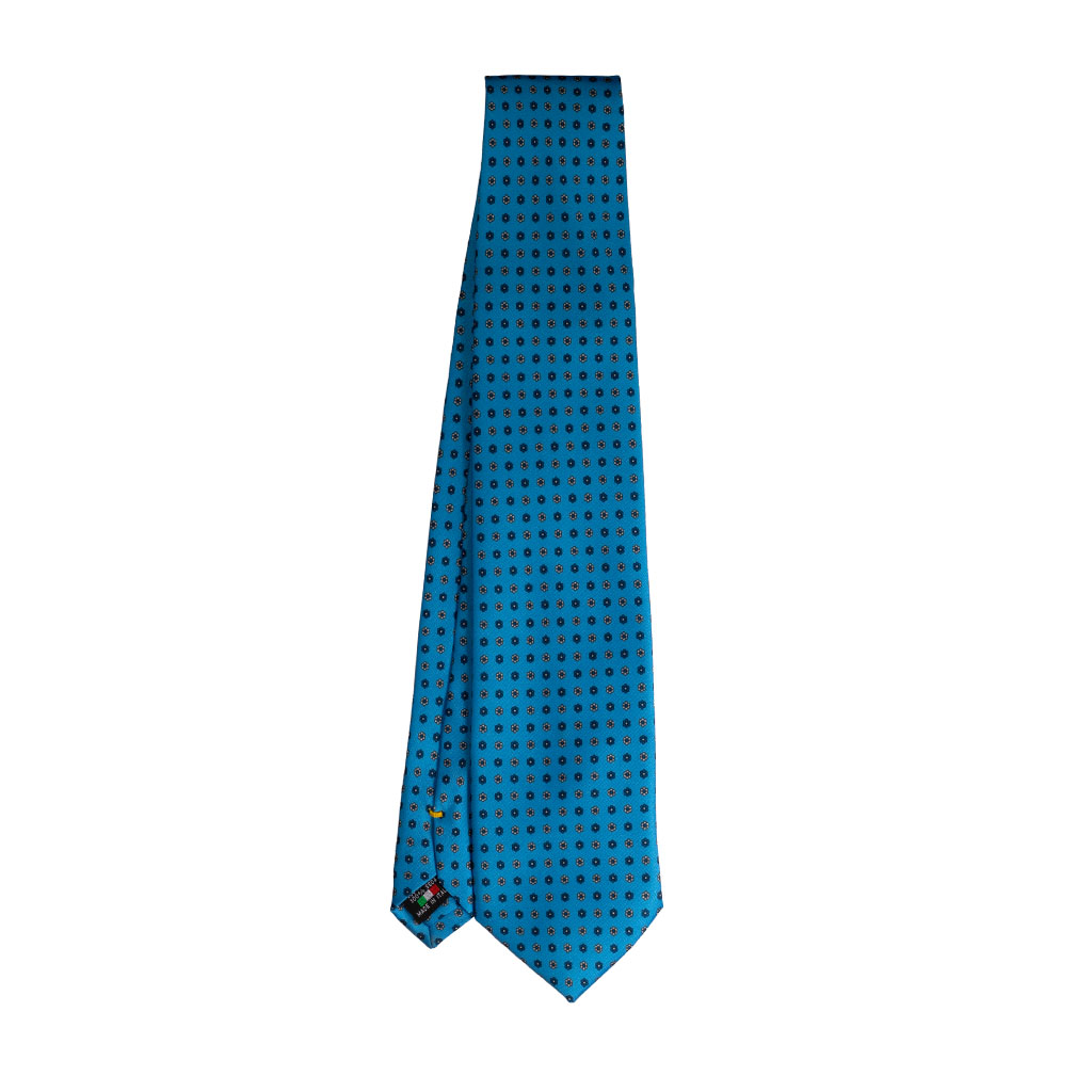 Cravatta azzurro micro fantasia floreale blue e bianco in twill di seta tre pieghe realizzata a mano in Italia. Cravatta micro fantasia floreale 3 pieghe