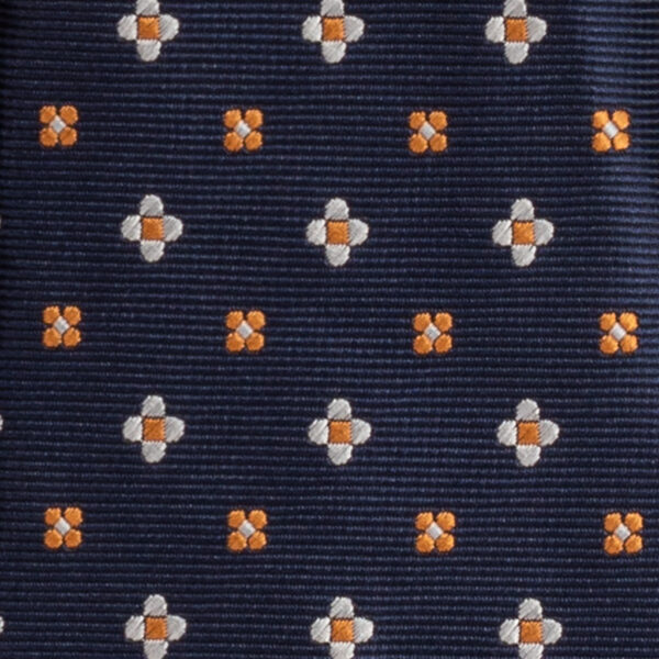 Cravatta blu micro fantasia arancione e bianco in twill di seta tre pieghe realizzata a mano in Italia. Cravatta blu micro fantasia 3 pieghe arancione
