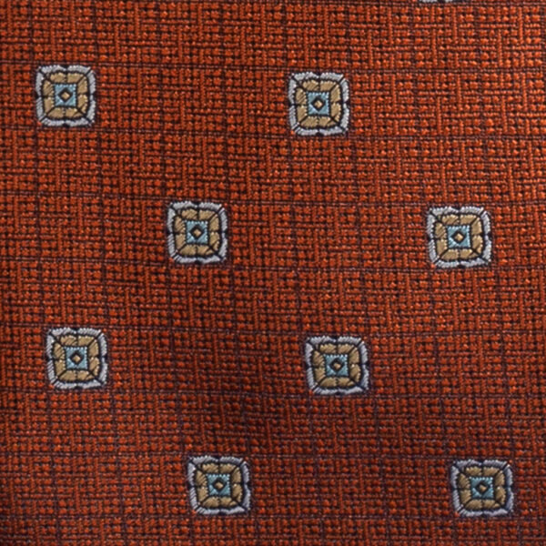 Cravatta arancione maxi fantasia celeste in twill di seta tre pieghe realizzata a mano in Italia. Cravatta arancione maxi fantasia 3 pieghe celeste