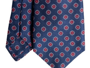 Cravatta blu micro fantasia floreale rosso bianco in seta jacquard sette pieghe realizzata a mano in Italia. Cravatta blu micro fantasia rosso sette pieghe