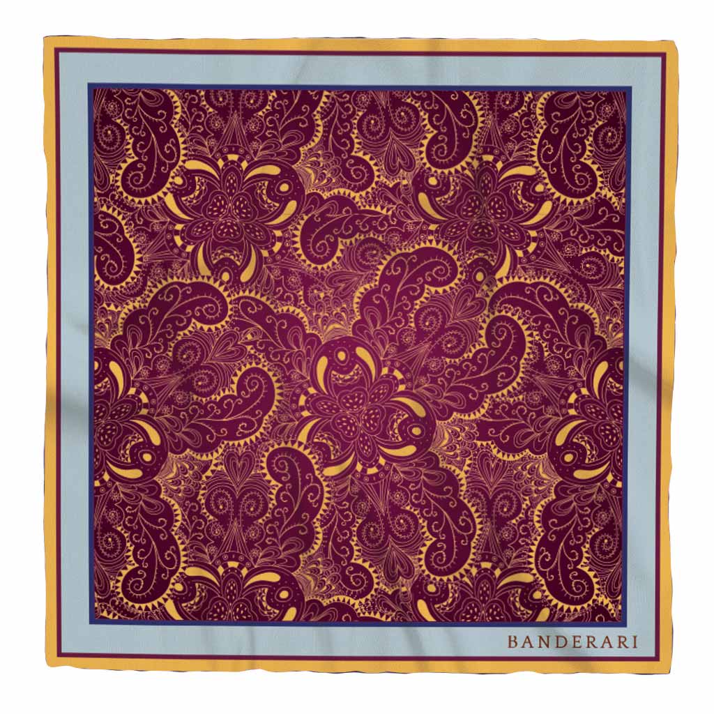 Elegante fazzoletto da taschino in seta orlata a mano dalla fantasia paisley bordeaux, giallo e azzurro. Pochette da giacca colorata e versatile.